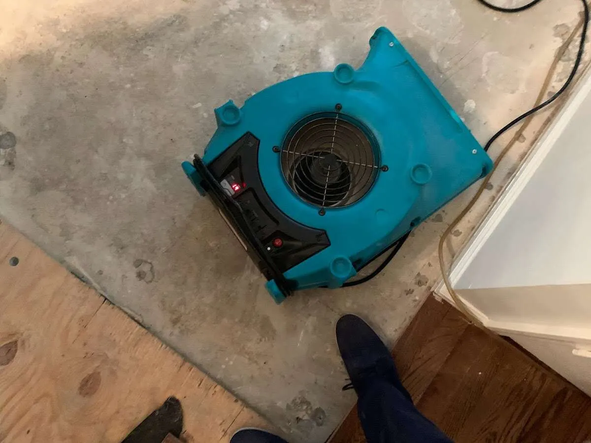 Air mover drying subfloor during Leak Detection & Repair in Three Lakes
